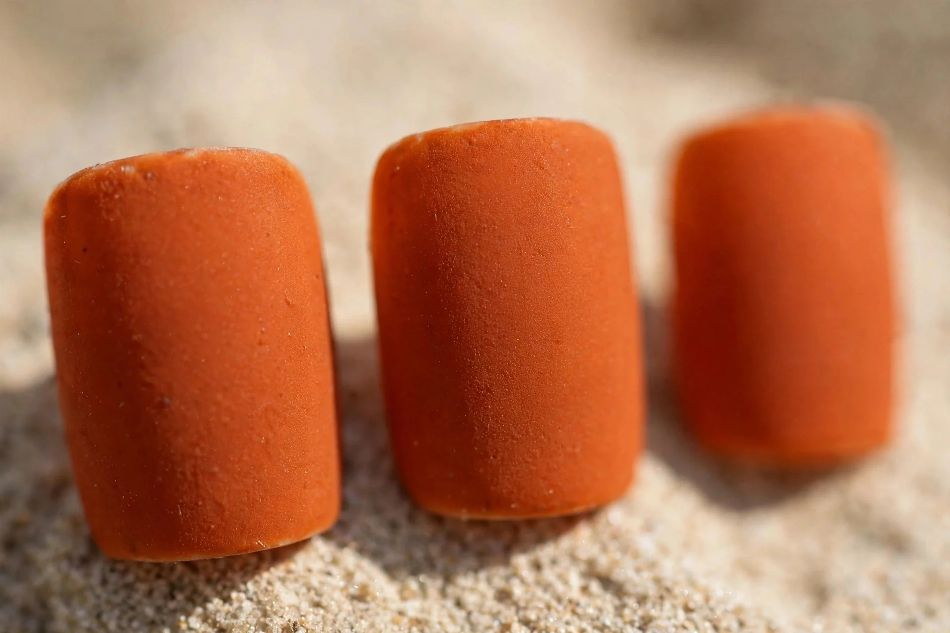 Burnt orange polish with matte top coat, short square nails