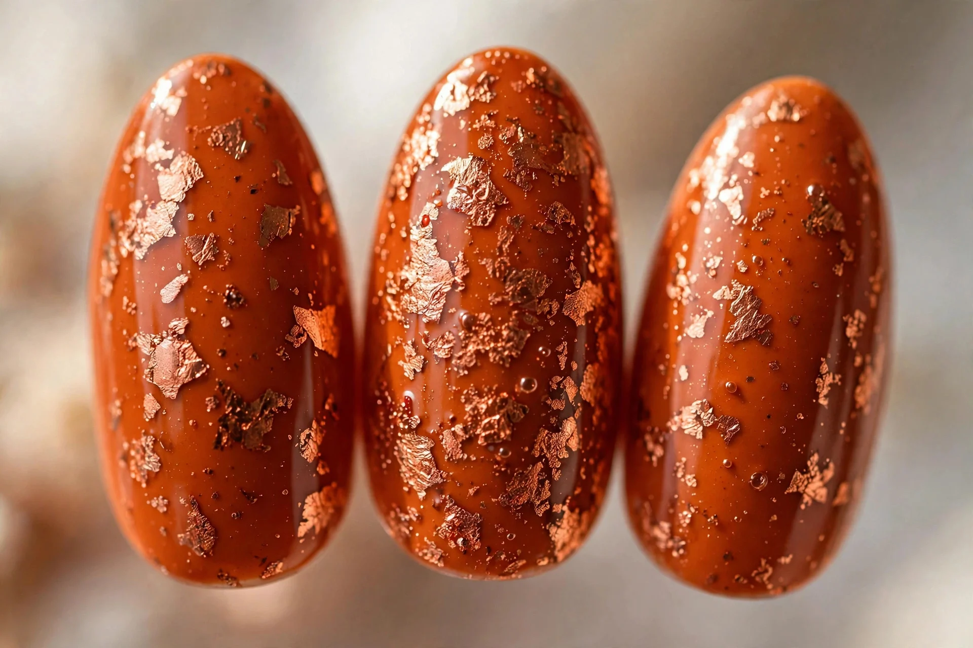Burnt orange nails with copper foil flakes, almond, glossy