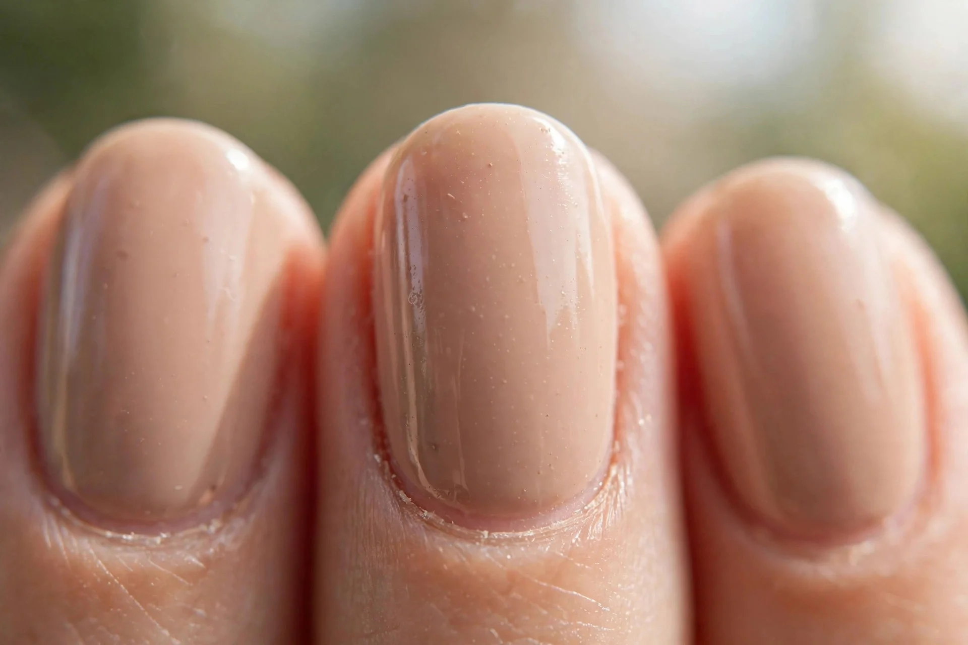 short oval nails in glossy nude beige polish