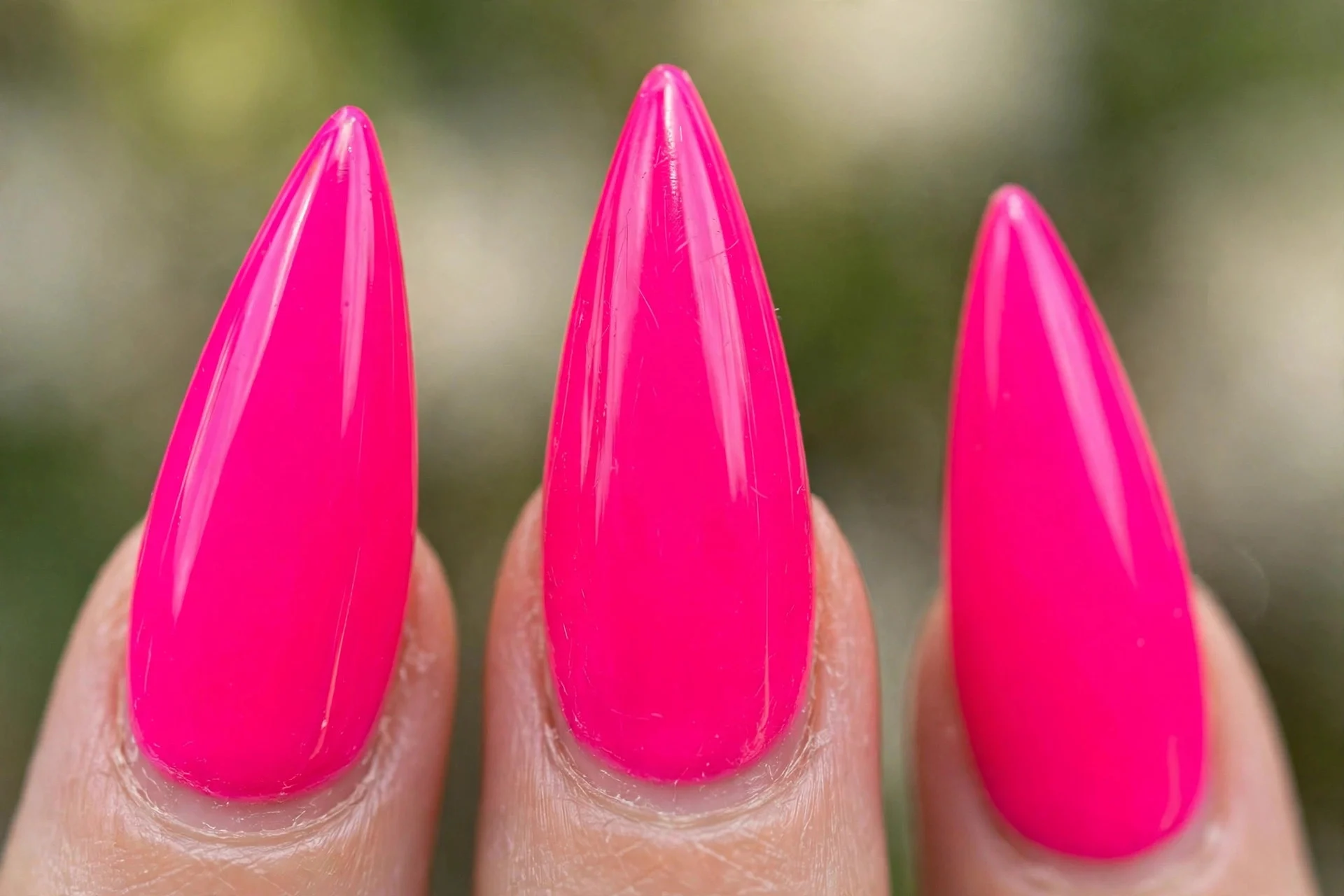 stiletto acrylic nails in bright neon pink