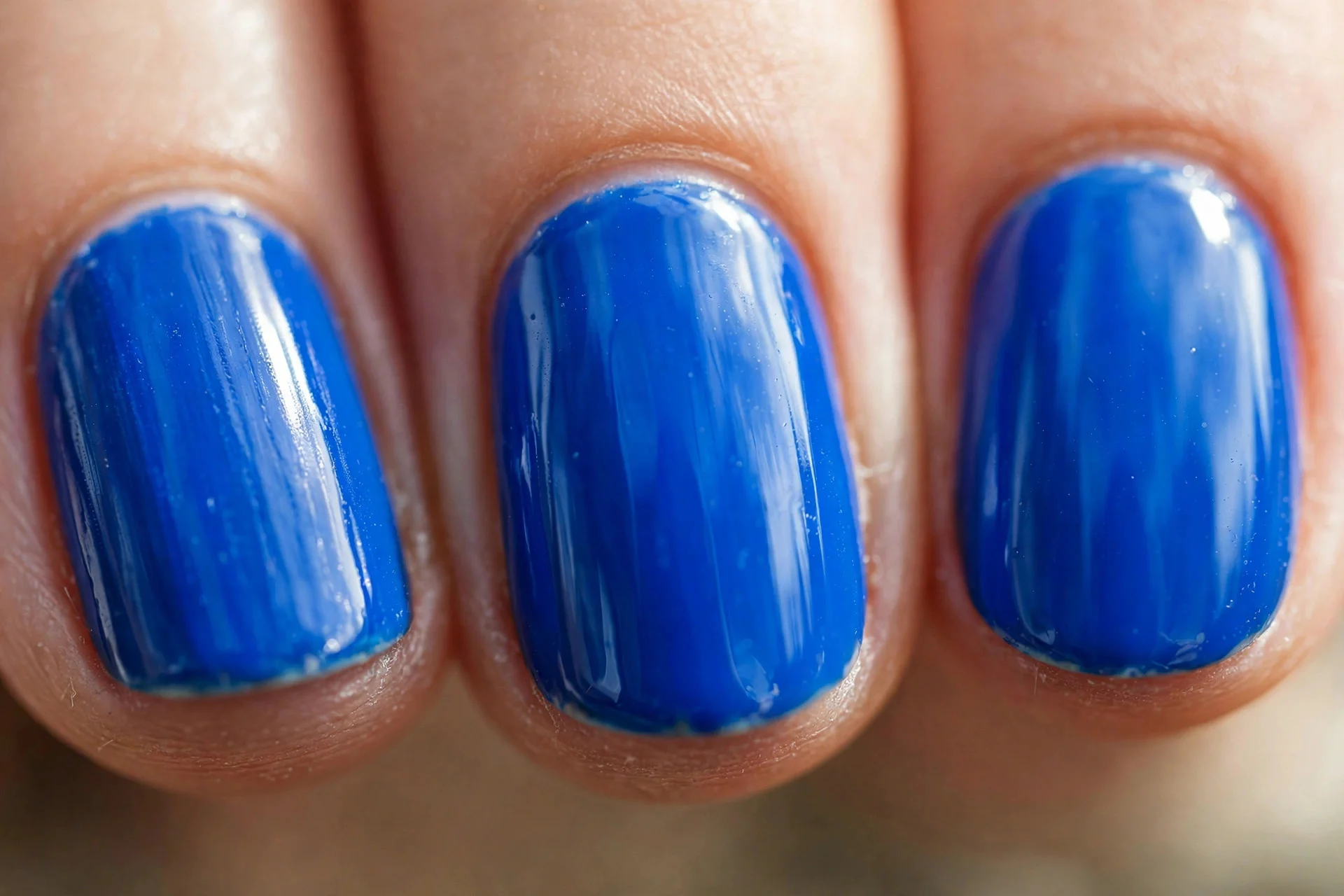 oval nails in vivid cobalt blue with a glassy shine