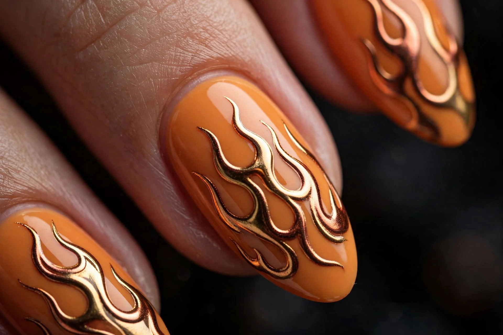 Long almond nails in pumpkin with gold and copper chrome flame art, glossy, dark background