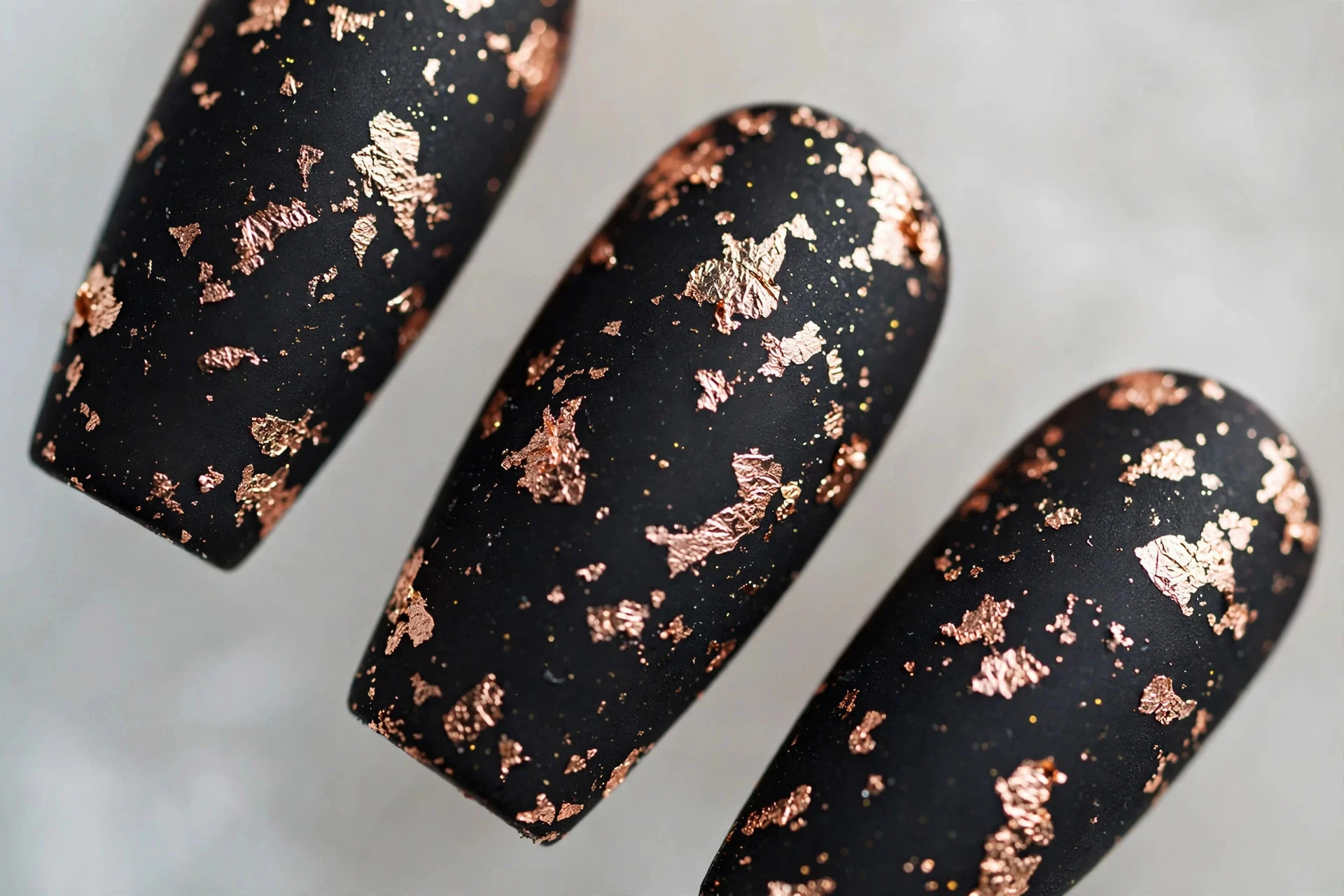 Matte black nails with rose gold foil flakes, medium coffin nails