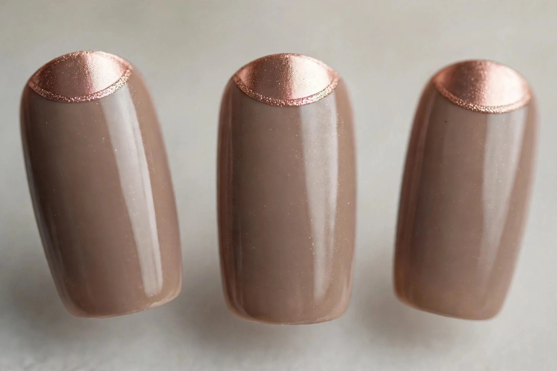 Warm taupe nails with rose gold half-moon cuticle accents, squoval