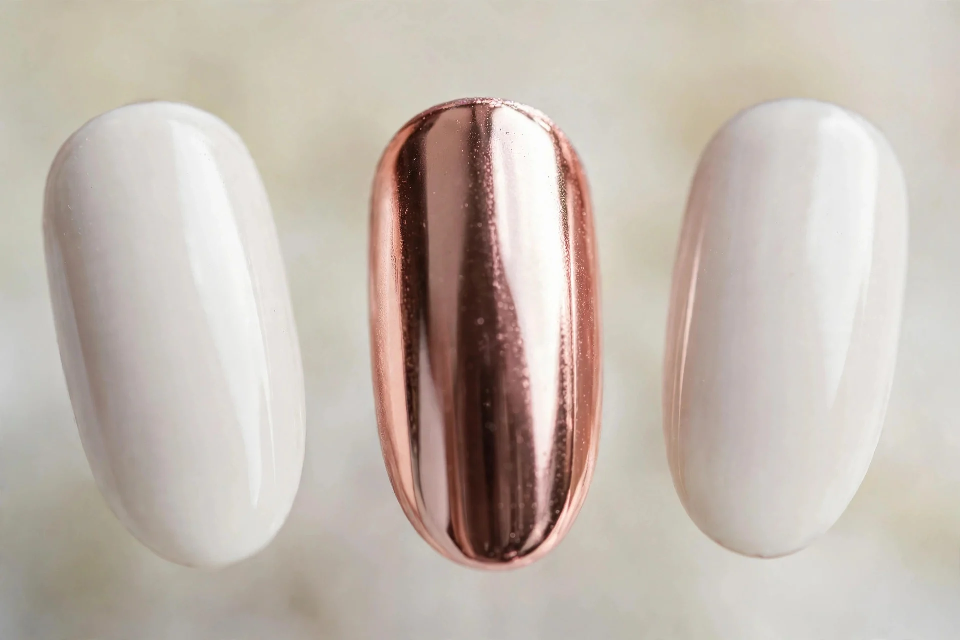 White nails with rose gold chrome accent nails, medium almond
