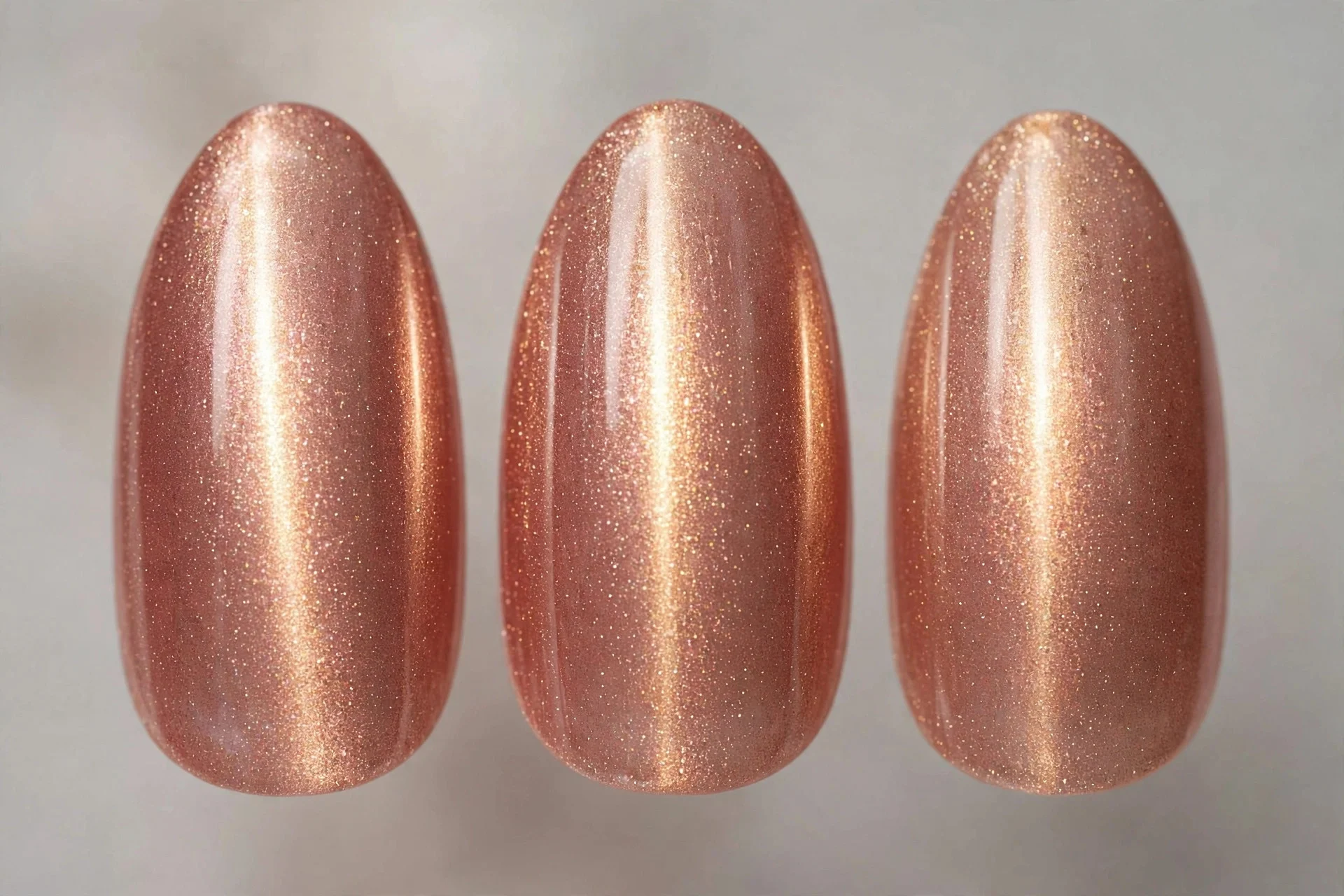 Rose gold magnetic cat-eye nails with glowing centre line, almond