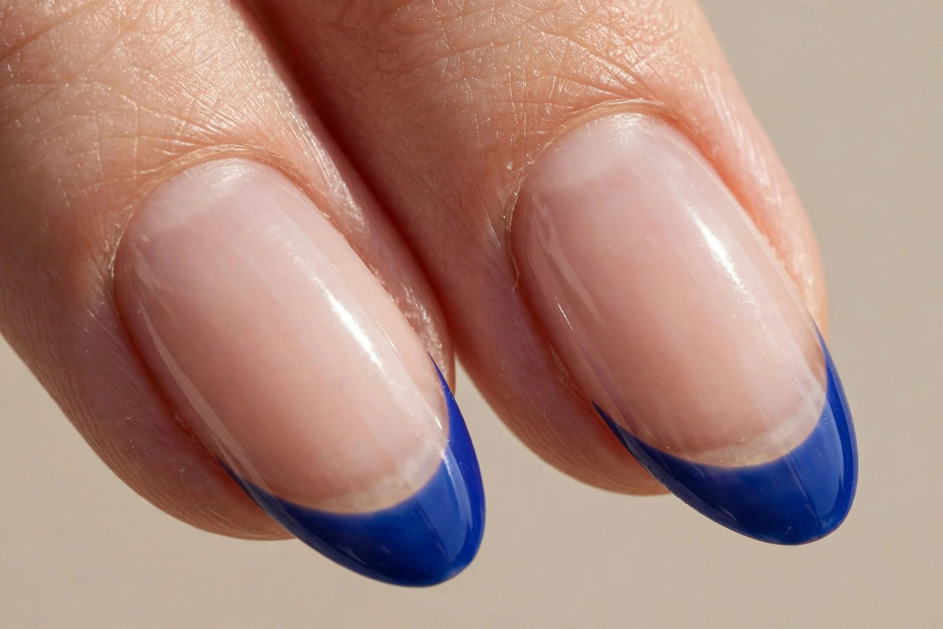 almond nails, nude base, sapphire French tips
