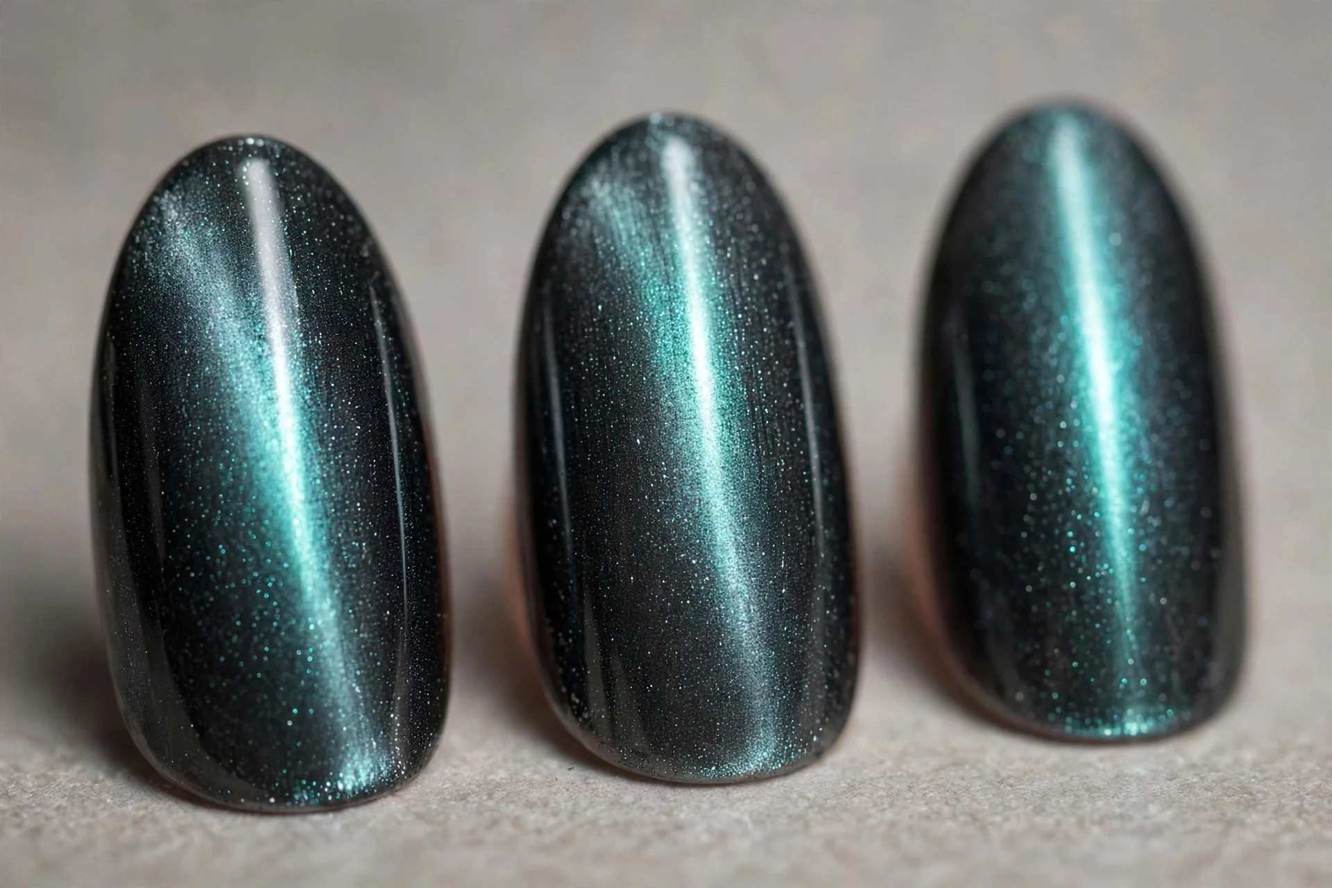Graphite magnetic cat-eye nails with glowing centre line, almond nails