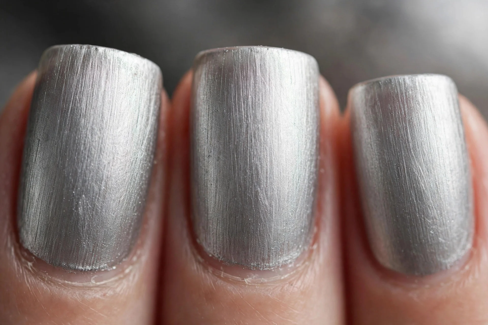 Brushed pewter silver nails with soft directional grain, short square