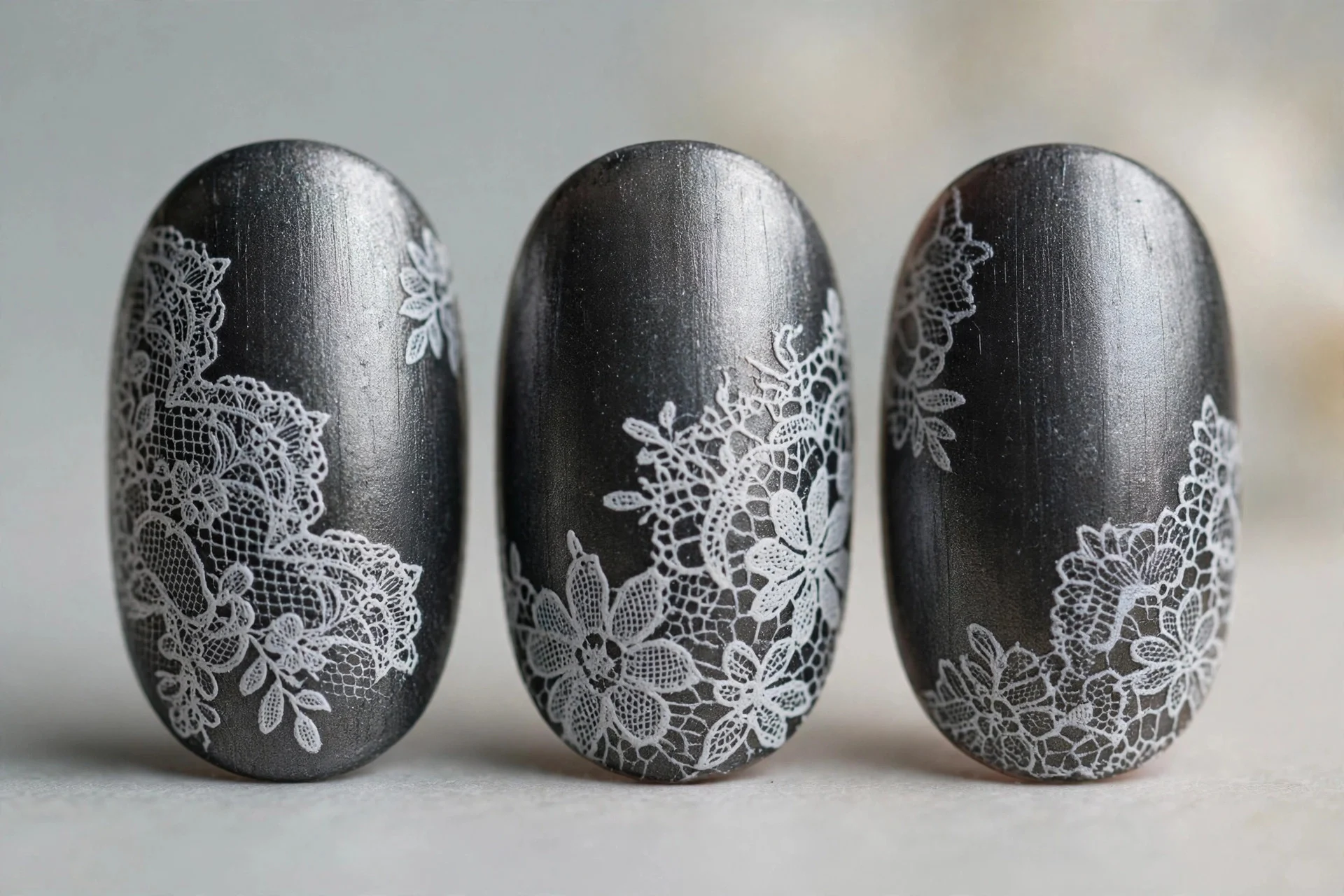 Deep pewter nails with delicate white lace stamp art, oval nails