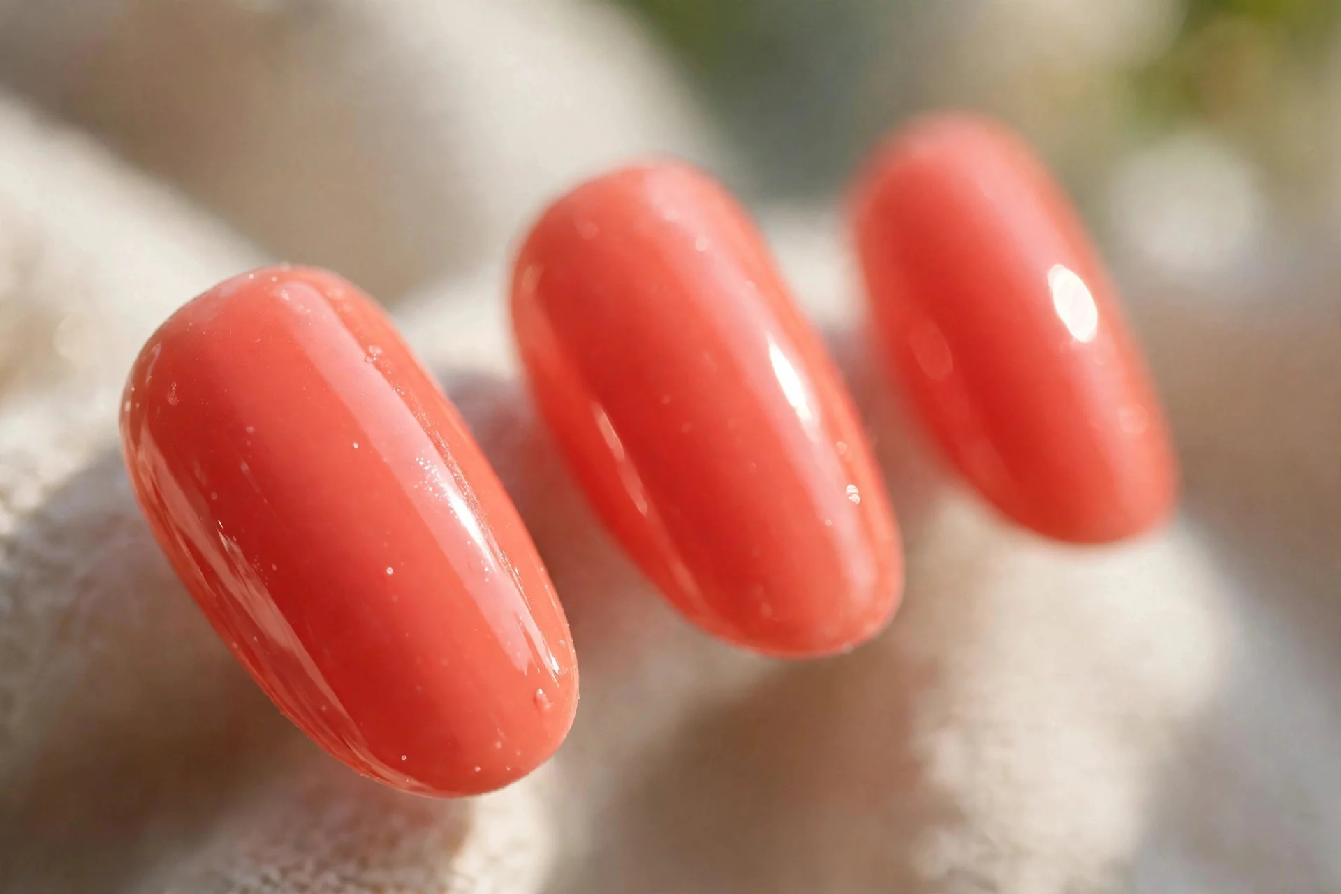 Glossy coral press-on nails, short almond shape