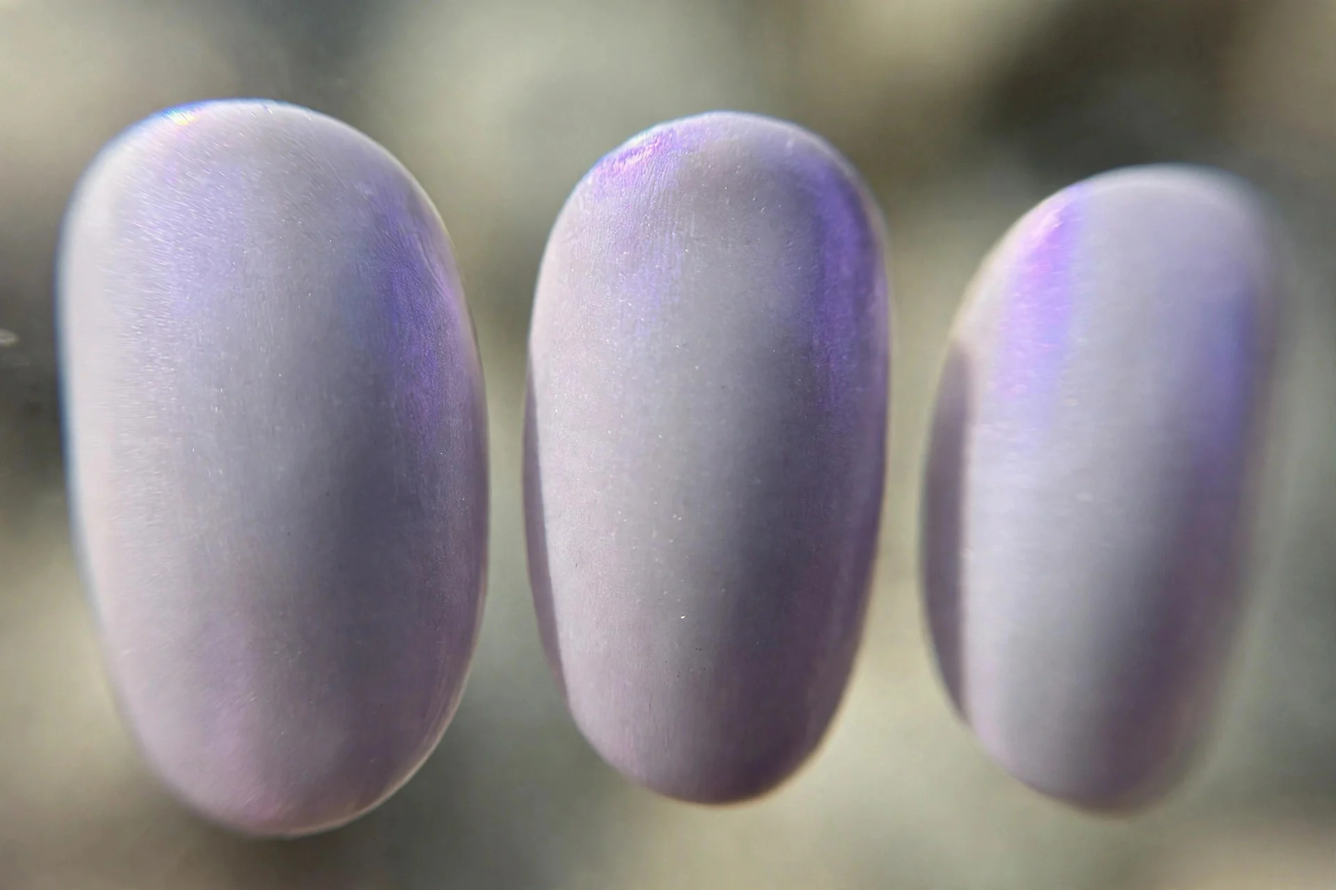 Milky lilac-grey polish, oval nails, subtle purple shift