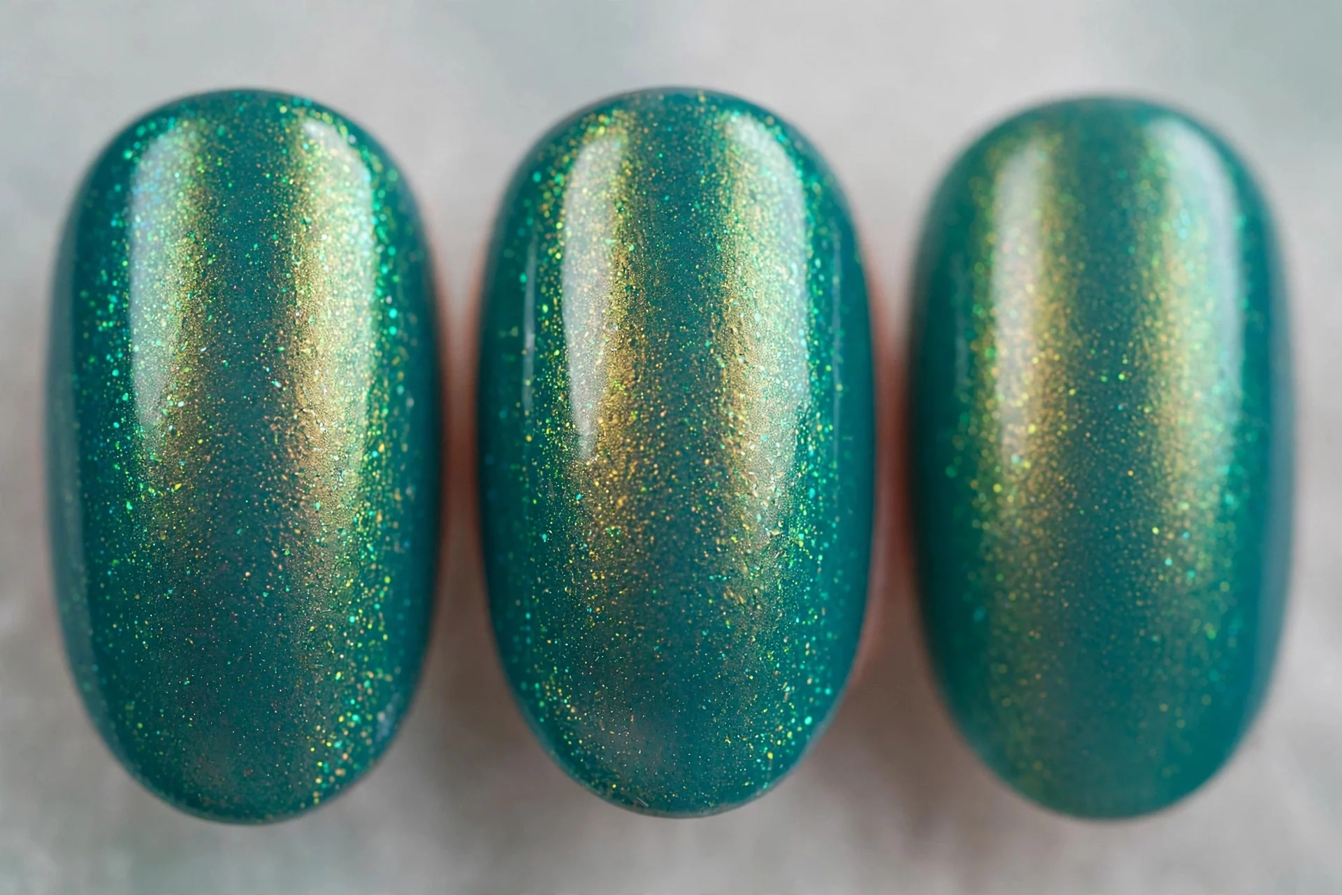 Teal polish with peacock green-gold shimmer, oval nails