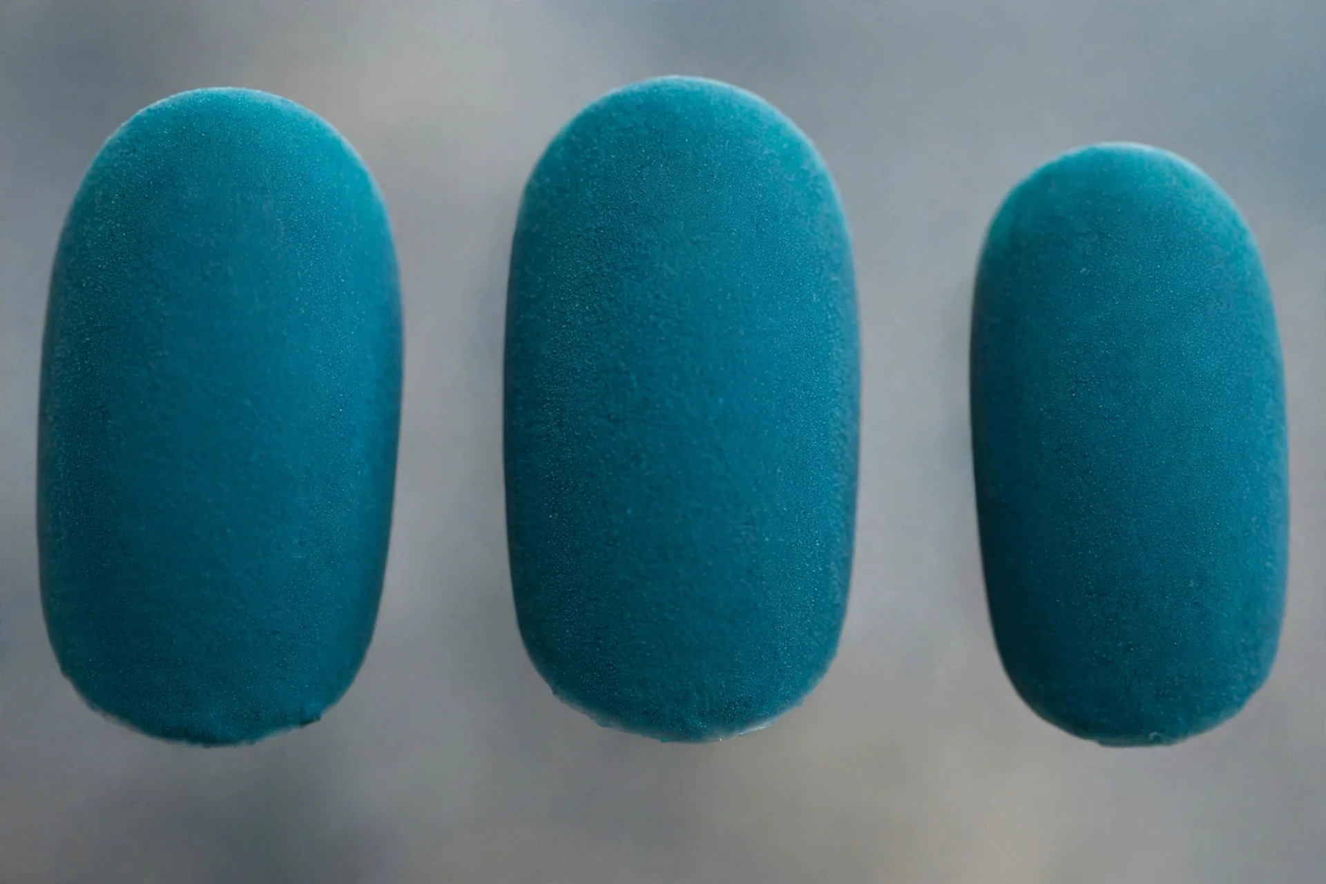 Teal polish with velvet matte texture, medium oval nails