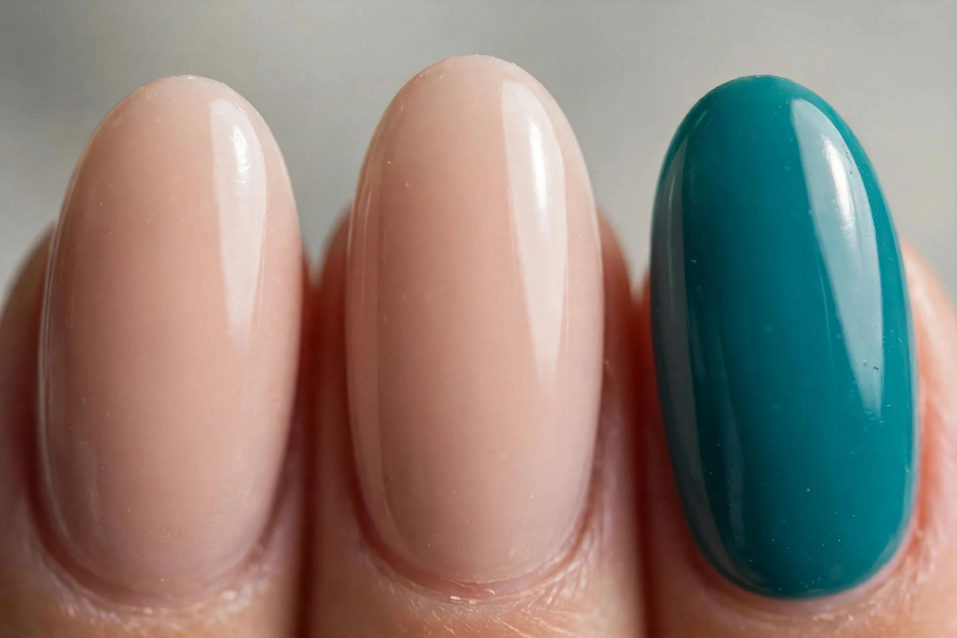 Nude nails with single teal accent nail, oval