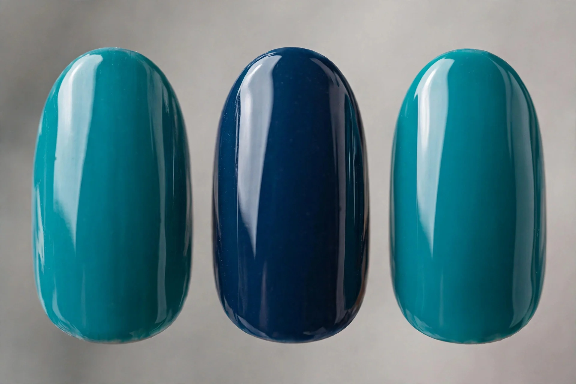 Alternating teal and navy nails, medium almond, glossy
