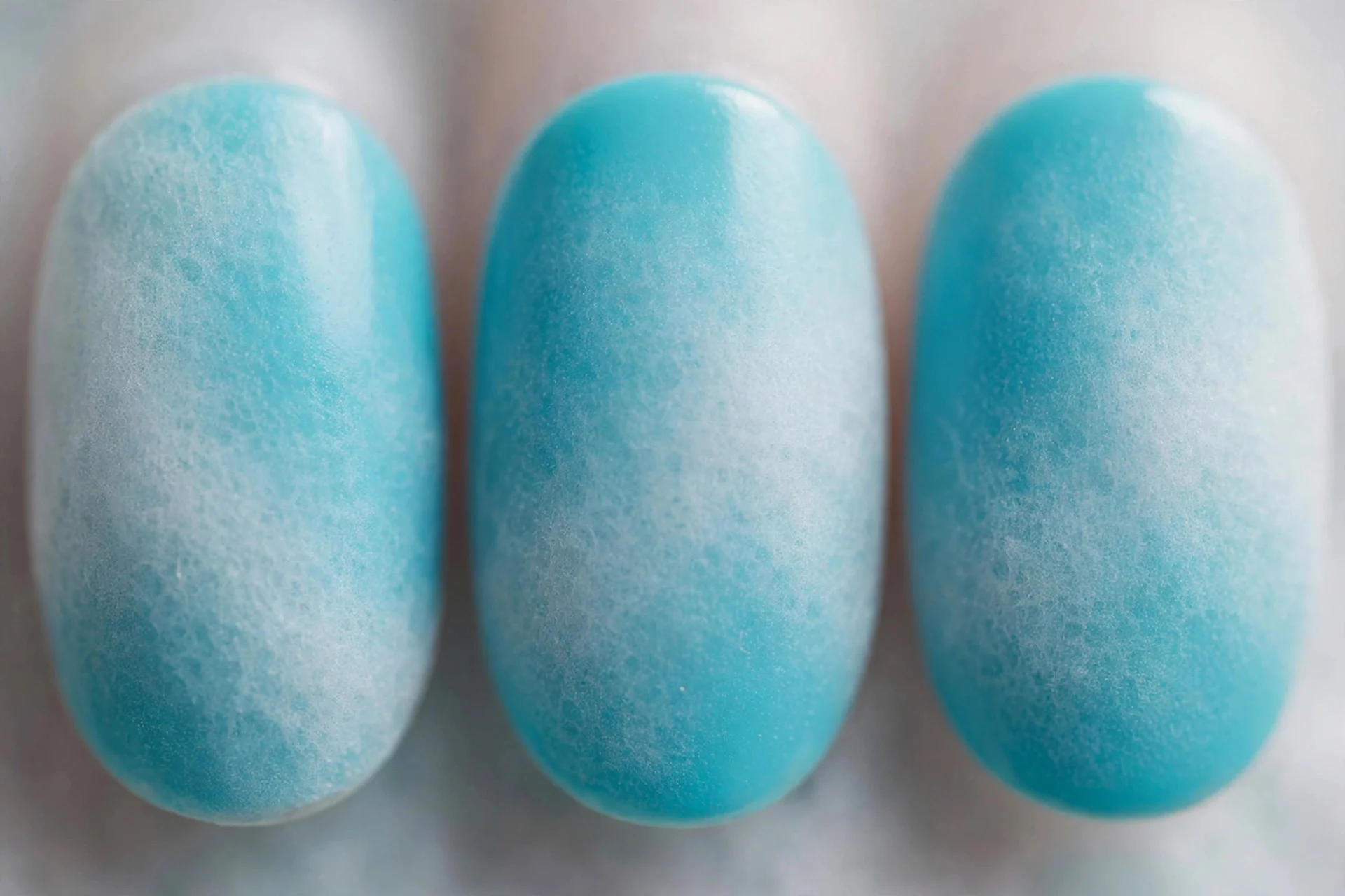 Turquoise nails with sheer white sponged haze, short oval