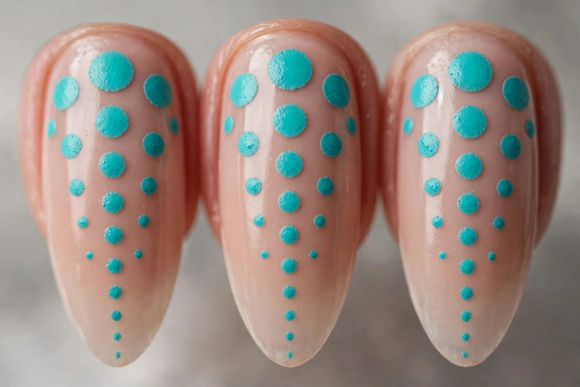 Turquoise dots fading from large to small, nude base, almond