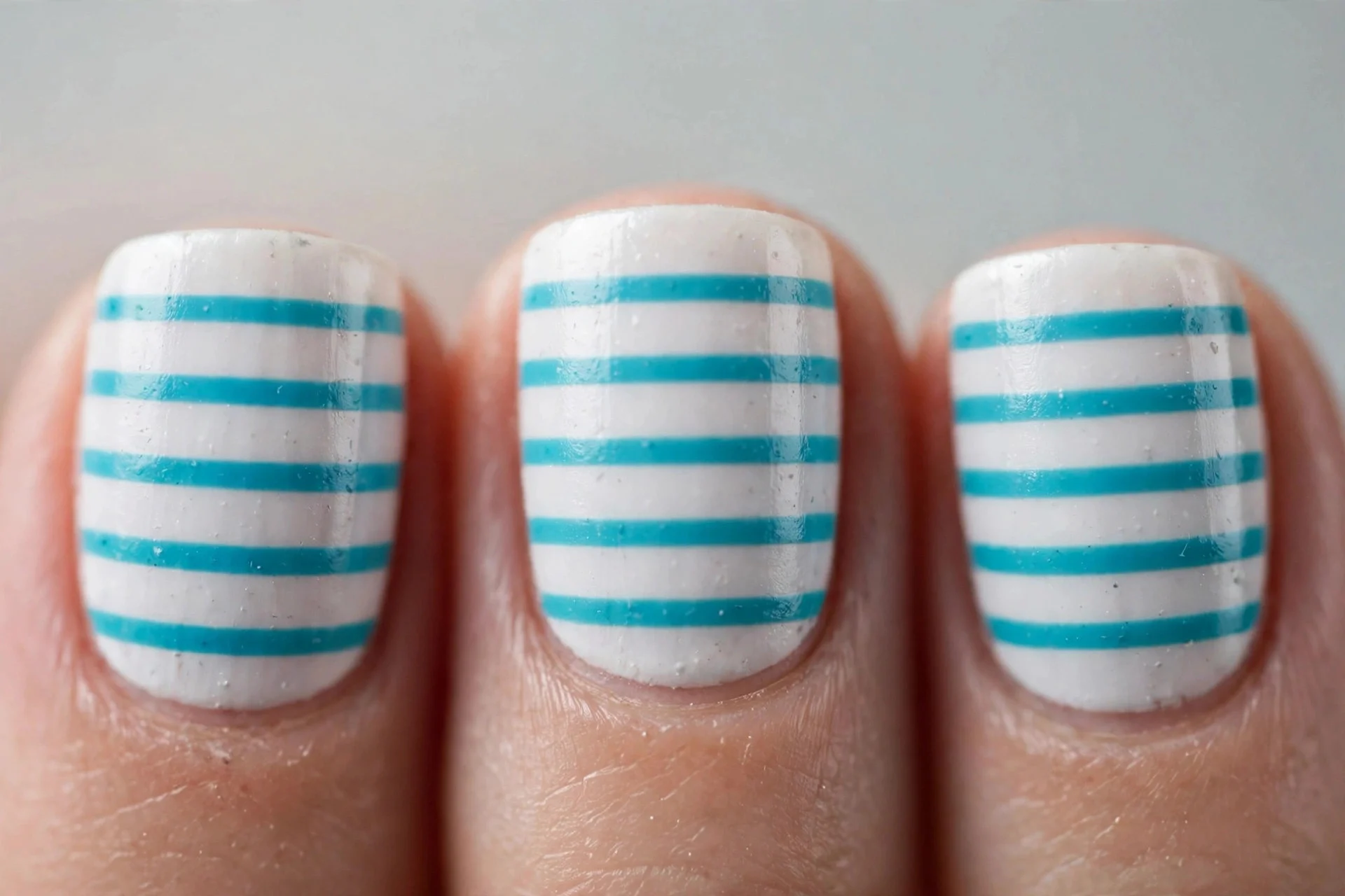 White nails with turquoise horizontal stripes, short square