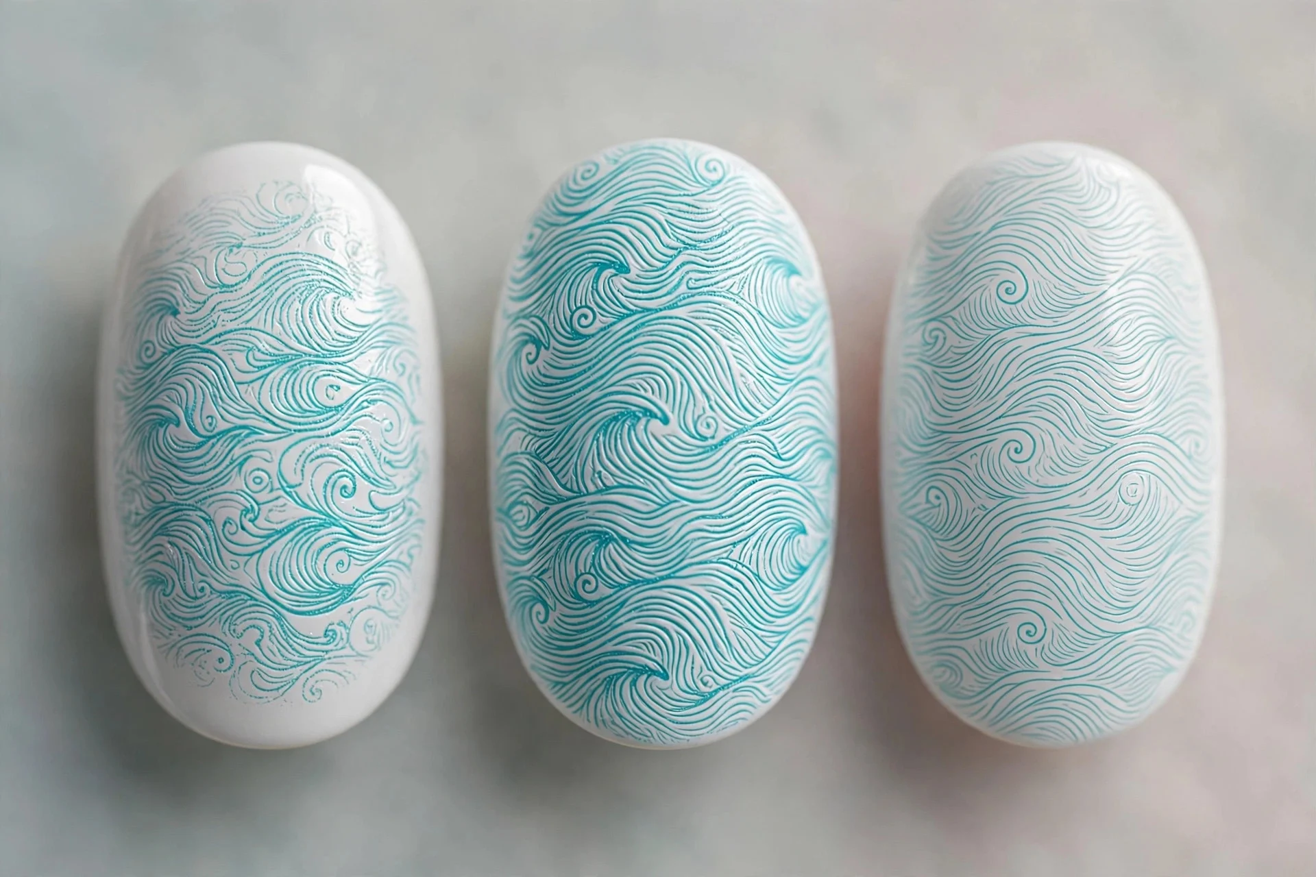 White nails with stamped turquoise wave pattern, oval