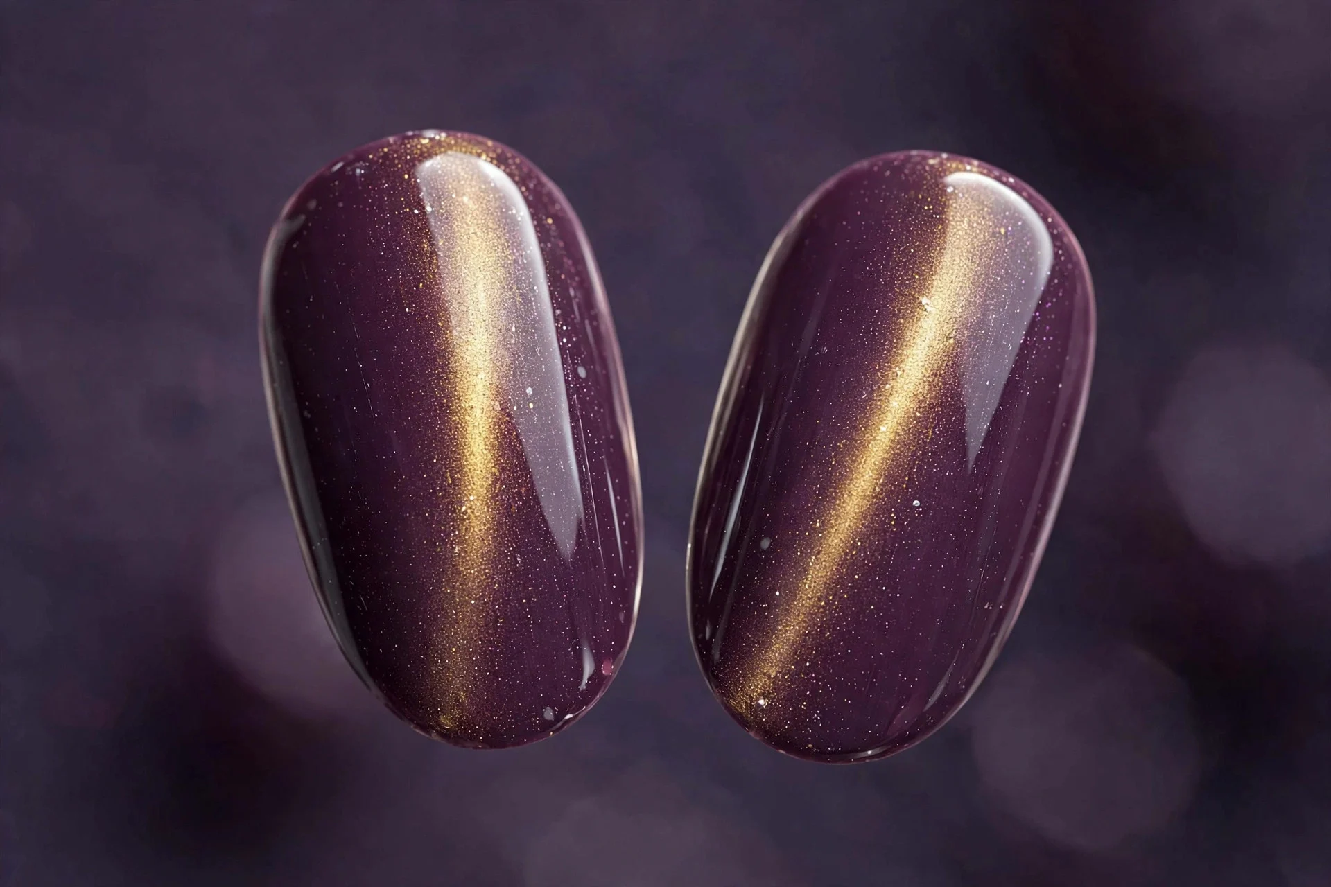 Extreme macro of two oval fingernails, plum cat-eye gel, gold band, glossy, purple-gray background