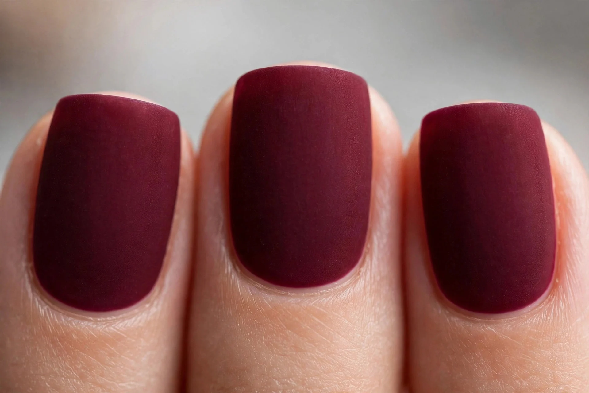 Wine burgundy polish with velvet matte texture, short square nails