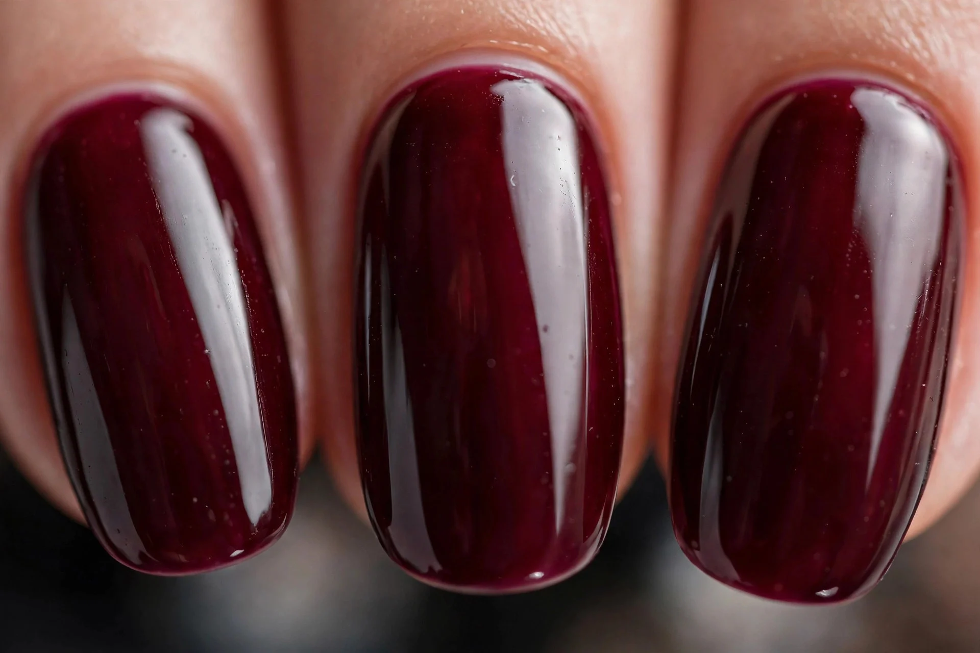 Deep oxblood wine polish, short almond nails, high gloss