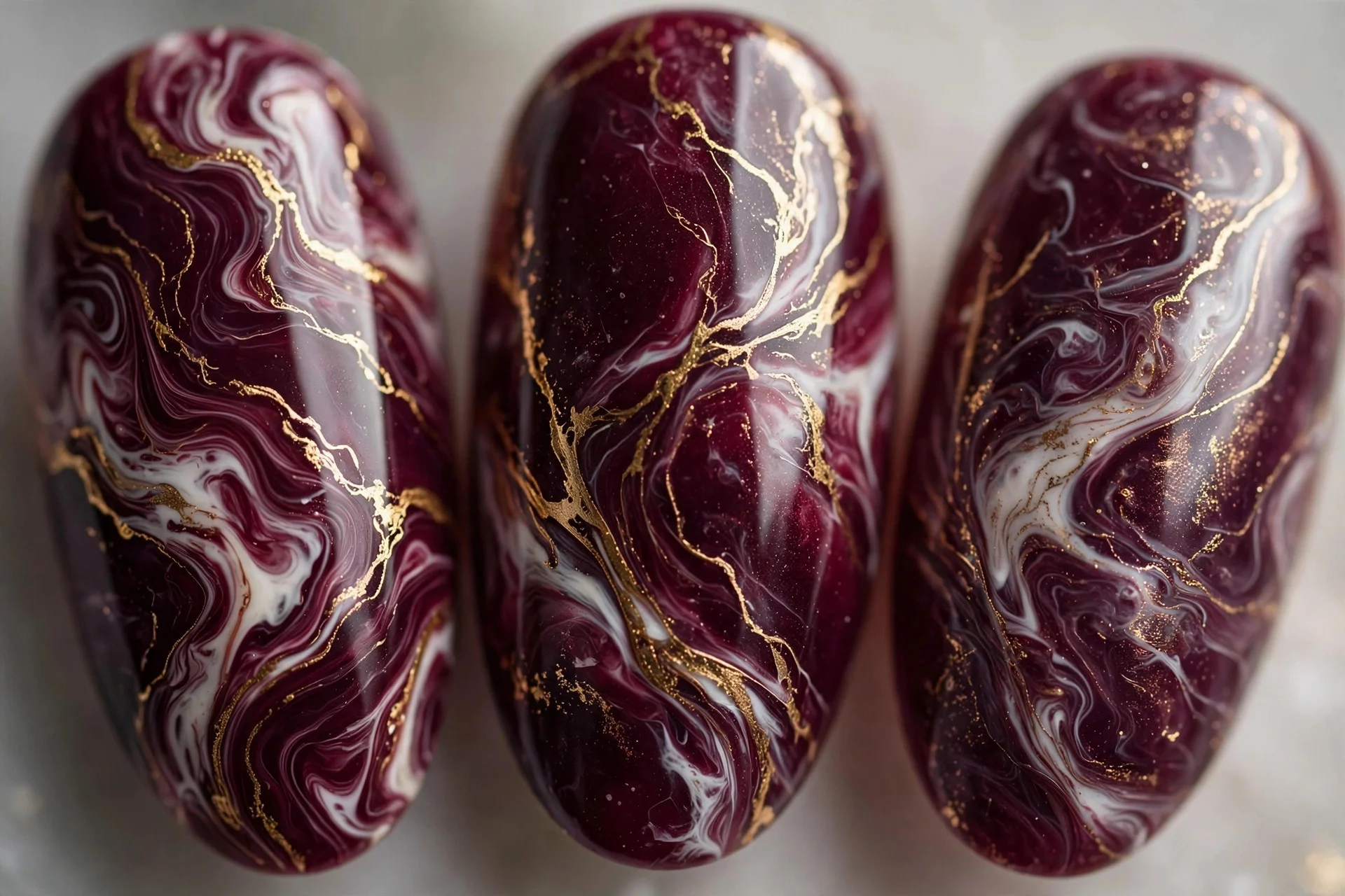 Deep wine marble with white and gold veining, almond nails